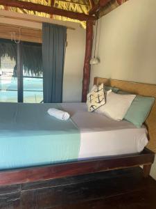 a bed sitting in a room with a window at Punta El Zonte in El Zonte +10 photos