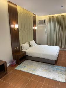 a bedroom with a large bed and a rug at شقق احد رفيدة in Ahad Rafidah +11 photos