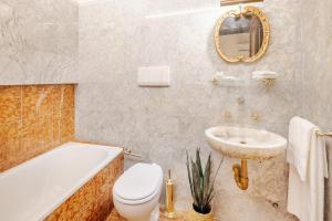 a bathroom with a tub and a toilet and a sink at Arezzo Centre, Prestigious Apartment with a View in Arezzo +65 photos