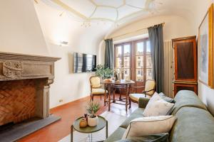 a living room with a couch and a fireplace at Arezzo Centre, Prestigious Apartment with a View in Arezzo