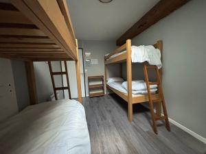 a room with two bunk beds and a bed at L'Embaradere in Laruns +11 photos