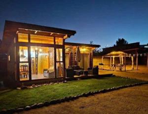 a small house with a lit up backyard at night at Hipolito in La Serena