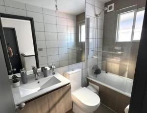 a bathroom with a sink and a toilet and a tub at Hipolito in La Serena