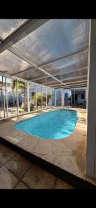 a large swimming pool in a large building with an open ceiling at Hotel Mar y Arte in Piriápolis