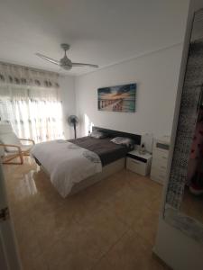 a bedroom with a bed and a ceiling fan at Le paradis de Lynn in Formentera de Segura +10 photos
