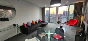 a living room with a couch and a glass table at Namah peace in Birmingham