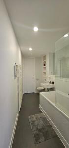 a white bathroom with a tub and a sink at Namah peace in Birmingham