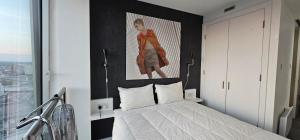 a bedroom with a bed with a painting on the wall at Shivay Harmony in Birmingham