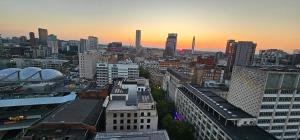 a view of a city at sunset with buildings at Shivay harmony in Birmingham