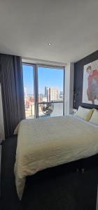 a bedroom with a large bed with a large window at Shivay harmony in Birmingham