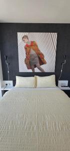 a bedroom with a bed with a picture of a woman at Shivay harmony in Birmingham +2 photos