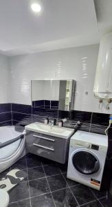 a bathroom with a sink and a washing machine in it at Villa Imperial in Dobra Voda +20 photos