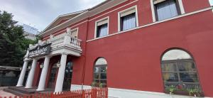 a red building with a sign on the side of it at Víghajós Panzió in Budapest