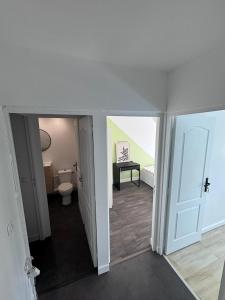 an empty room with a toilet and a door at Michèle Home in Orly