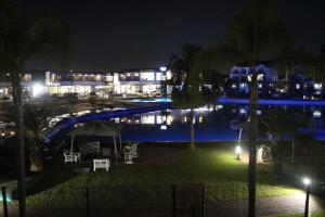 a view of a swimming pool at night at First Gen lagoon facing luxury apartment in Pretoria