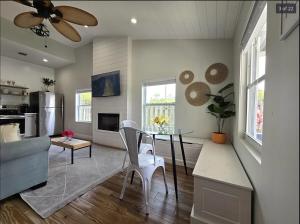 a living room with a table and a couch at Endless Summer Cottage - Steps off Atlantic! in Delray Beach