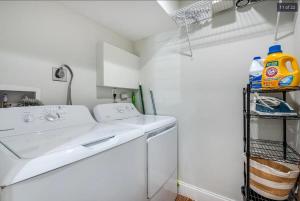 a white laundry room with a washer and dryer at Endless Summer Cottage - Steps off Atlantic! in Delray Beach