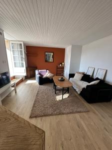 a living room with a couch and a table at Maison Icard in Sault-de-Vaucluse