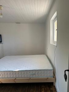 a bedroom with a bed in a room with a window at Maison Icard in Sault-de-Vaucluse