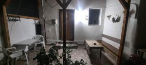 a room with a bed and a table and a bench at Daria in Eforie Sud +6 photos