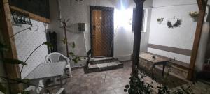 a room with a porch with a chair and a table at Daria in Eforie Sud