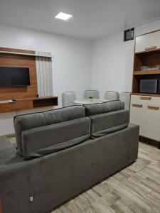 a living room with a couch and a table at Apartamento no Centro de Macapá - Edifício Fernando Dias in Macapá +12 photos