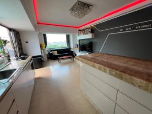 a kitchen with red ceilings and a living room at PENTHOUSE GROUP 4 Apartments in Bucharest