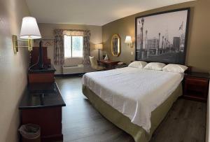 a hotel room with a bed and a large window at Knights Inn Hartford in Hartford +7 photos