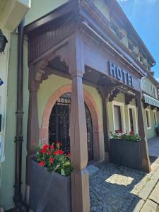 a hotel with flowers in front of a building at L'Ecrin Vert & Spa in Kaysersberg