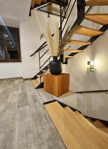 a room with a vase with a plant in it at L'Ecrin Vert & Spa in Kaysersberg