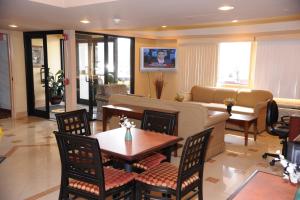 a living room with a couch and a table and chairs at Knights Inn Hartford in Hartford