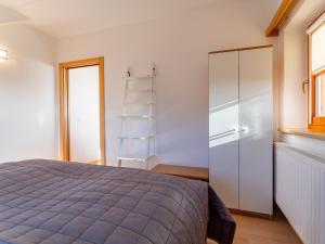 a bedroom with a bed and a white closet at Fanningberg in Mariapfarr +21 photos