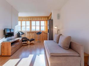 a living room with a couch and a tv at Fanningberg in Mariapfarr