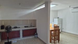 a kitchen with a refrigerator and a table and chairs at Villa Intan 2 in Amed