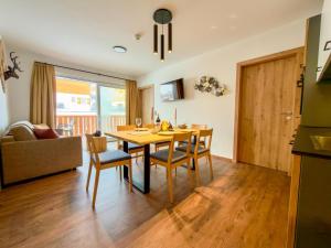 a kitchen and dining room with a table and chairs at Bockblick Top 5 in Weisspriach
