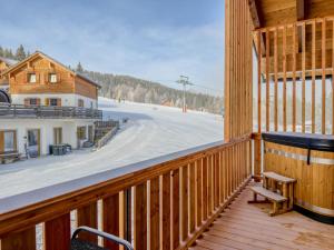 a wooden balcony with a view of a ski slope at Bockblick Top 5 in Weisspriach