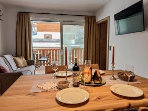 a dining room table with glasses and a bottle of wine at Bockblick Top 5 in Weisspriach +24 photos