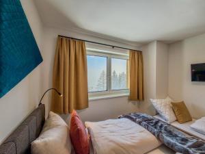 a living room with a couch and a window at Bockblick Top 6 in Weisspriach