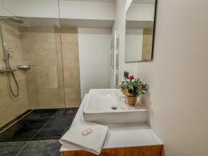 a bathroom with a tub and a shower and a sink at Bockblick Top 6 in Weisspriach +25 photos