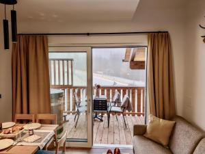 a living room with a view of a balcony at Bockblick Top 6 in Weisspriach