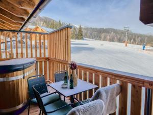 a balcony with a table and chairs on a ski slope at Bockblick Top 6 in Weisspriach