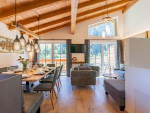 a dining room and living room with a table and chairs at Felsener Wald in Wald im Pinzgau