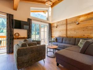 a living room with a couch and a chair at Felsener Wald in Wald im Pinzgau