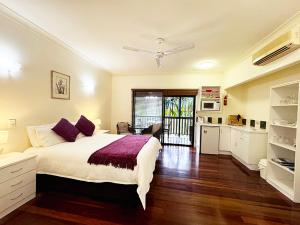 a bedroom with a large bed and a kitchen at True North B&B in Horseshoe Bay