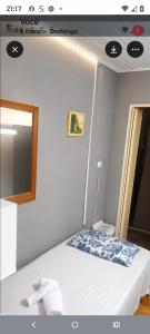 a room with a bed with a mirror and a bed sidx sidx sidx at Casa Hospedagem 01 in Foz do Iguaçu