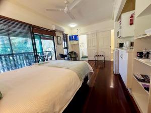 a bedroom with a large bed and a kitchen at True North B&B in Horseshoe Bay