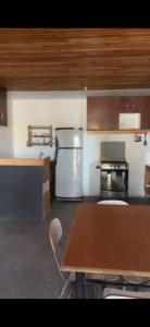 a kitchen with a table and a counter top at Casa La Tirana Parcela 43 in La Tirana