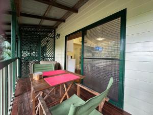 a porch with a wooden table and chairs on a patio at True North B&B in Horseshoe Bay +10 photos