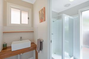 a bathroom with a sink and a glass shower at Wild Views in Tathra +28 photos