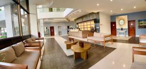 a lobby with a couch and chairs and tables at Ocean View Beach Hotel in Mazatlán